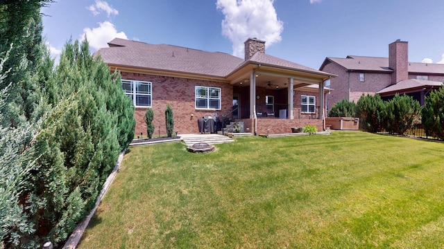 1007 Via Francesco Way, Spring Hill, TN 37174 - rear view of property with a ceiling fan, a yard, a chimney, and brick siding