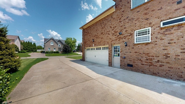 1007 Via Francesco Way, Spring Hill, TN 37174 - view of home's exterior featuring concrete driveway, brick siding, an attached garage, and a yard