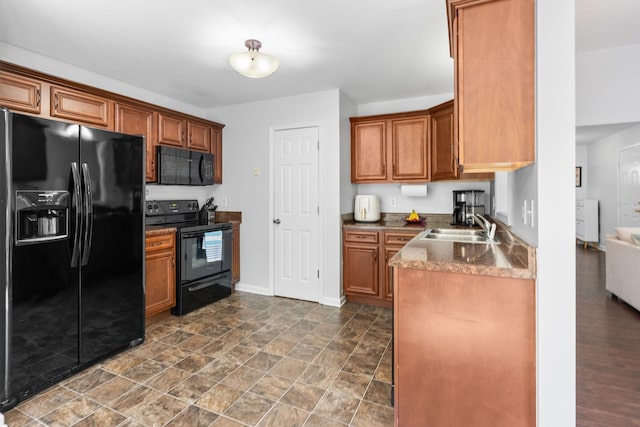 508 Oakmont Dr, Clarksville, TN 37042 - kitchen featuring black appliances, brown cabinetry, and dark countertops