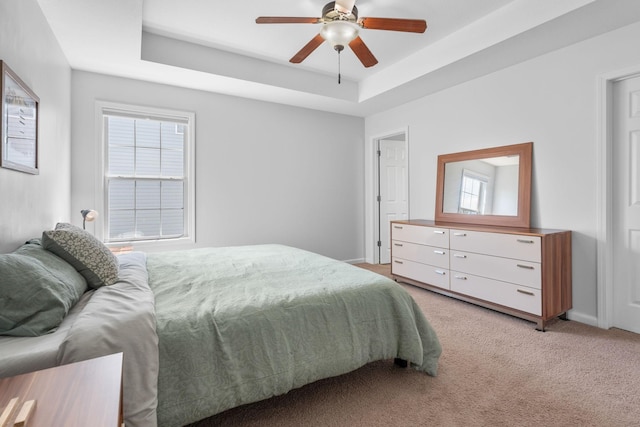508 Oakmont Dr, Clarksville, TN 37042 - bedroom with multiple windows, a raised ceiling, light colored carpet, and a ceiling fan