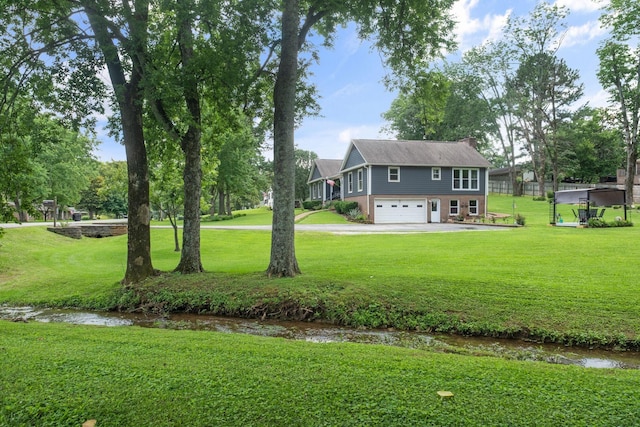 1400 Manor Rd, Columbia, TN 38401 - view of green lawn with a garage and driveway