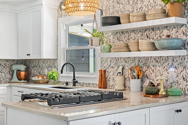 1400 Manor Rd, Columbia, TN 38401 - kitchen featuring open shelves, tasteful backsplash, white cabinets, stainless steel gas stovetop, and a chandelier