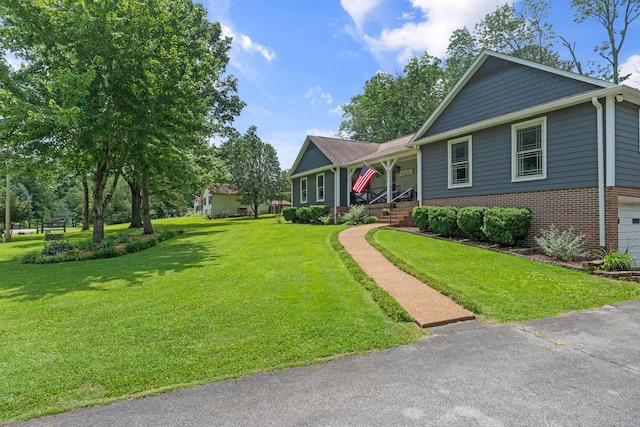 1400 Manor Rd, Columbia, TN 38401 - ranch-style house featuring brick siding, covered porch, a front lawn, and an attached garage