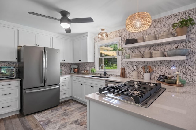 1400 Manor Rd, Columbia, TN 38401 - kitchen with stainless steel appliances, white cabinets, backsplash, and light countertops