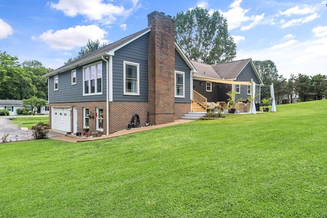1400 Manor Rd, Columbia, TN 38401 - back of property with a chimney, a yard, a garage, brick siding, and driveway