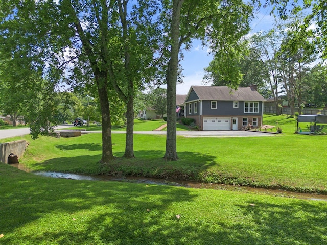 1400 Manor Rd, Columbia, TN 38401 - view of green lawn with an attached garage and driveway