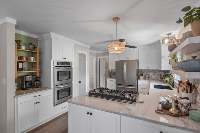 1400 Manor Rd, Columbia, TN 38401 - kitchen with open shelves, stainless steel appliances, a peninsula, backsplash, and white cabinets