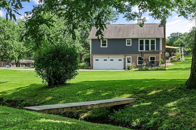 1400 Manor Rd, Columbia, TN 38401 - back of house with brick siding, a garage, and a yard