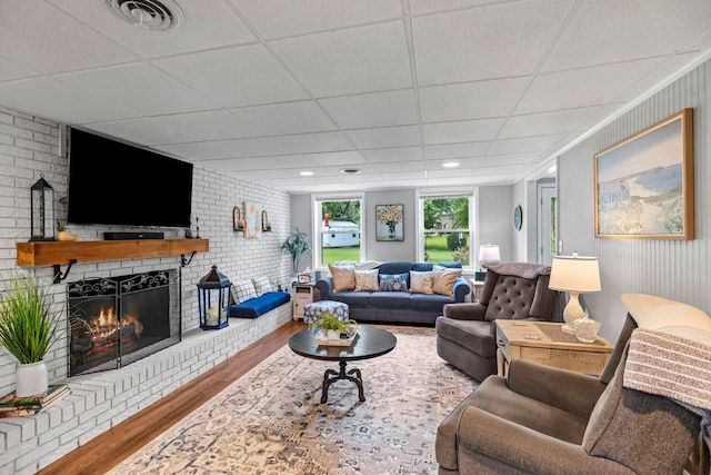 1400 Manor Rd, Columbia, TN 38401 - living room featuring wood finished floors, a drop ceiling, and a fireplace