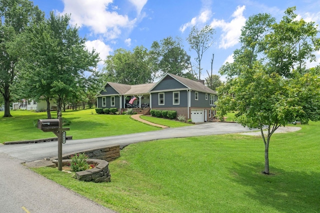 1400 Manor Rd, Columbia, TN 38401 - ranch-style home with asphalt driveway, a garage, a front lawn, brick siding, and covered porch
