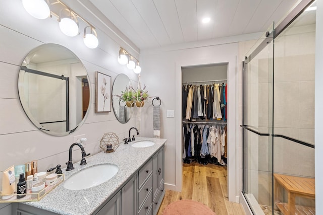 1400 Manor Rd, Columbia, TN 38401 - full bath featuring double vanity, wood finished floors, a stall shower, and a walk in closet