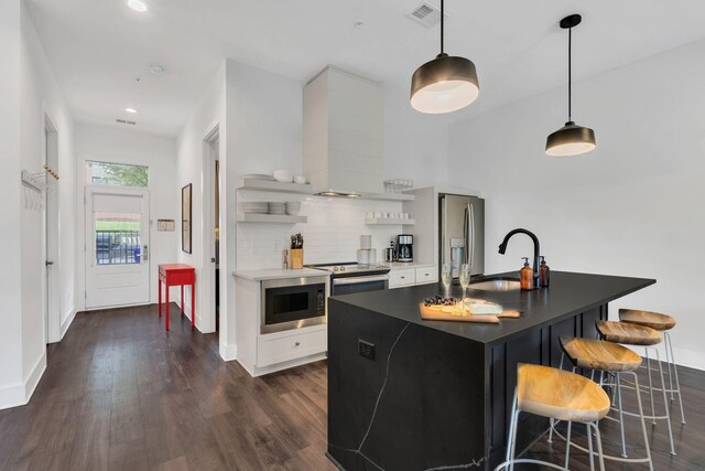1320 5th Ave N Unit 4, Nashville, TN 37208 - kitchen with appliances with stainless steel finishes, open shelves, dark wood-style flooring, white cabinets, and dark countertops