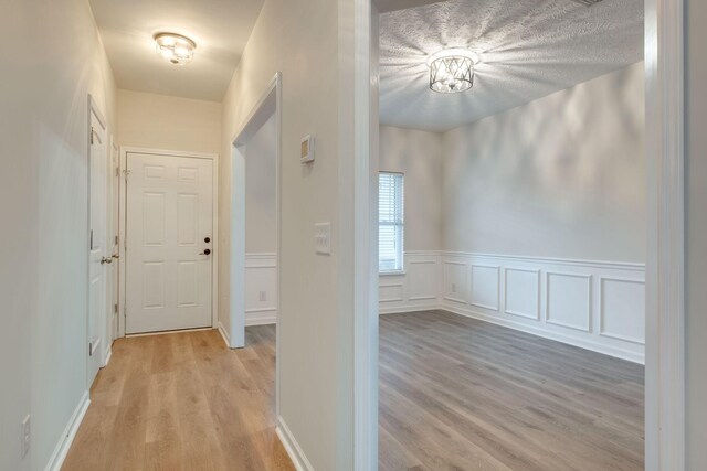 317 Sarava Ln, Smyrna, TN 37167 - corridor featuring light wood finished floors and wainscoting