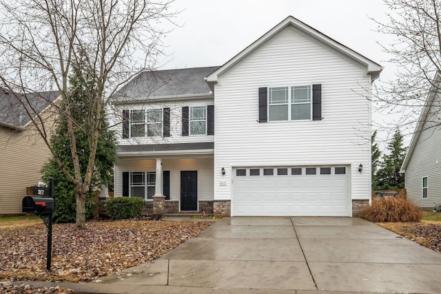 317 Sarava Ln, Smyrna, TN 37167 - traditional-style home featuring an attached garage, driveway, covered porch, and stone siding