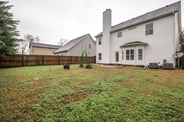317 Sarava Ln, Smyrna, TN 37167 - back of property with a fenced backyard, a chimney, and a patio