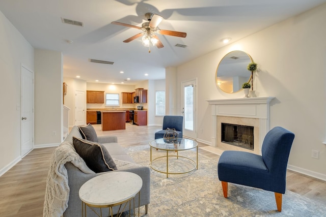 317 Sarava Ln, Smyrna, TN 37167 - living area with light wood-style flooring, ceiling fan, a high end fireplace, and recessed lighting