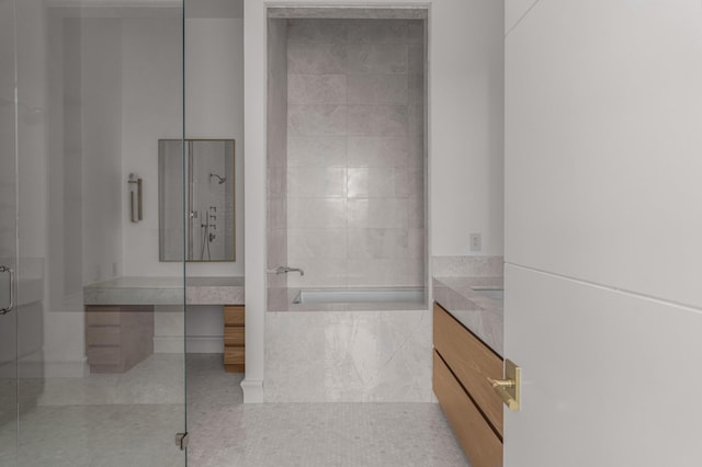 1616 W End Ave Unit 3304, Nashville, TN 37203 - bathroom with vanity, a tile shower, a tub to relax in, tile patterned flooring, and tile walls