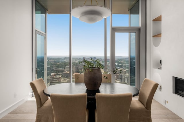 1616 W End Ave Unit 3304, Nashville, TN 37203 - dining area with wood finished floors, a wall of windows, and a view of city
