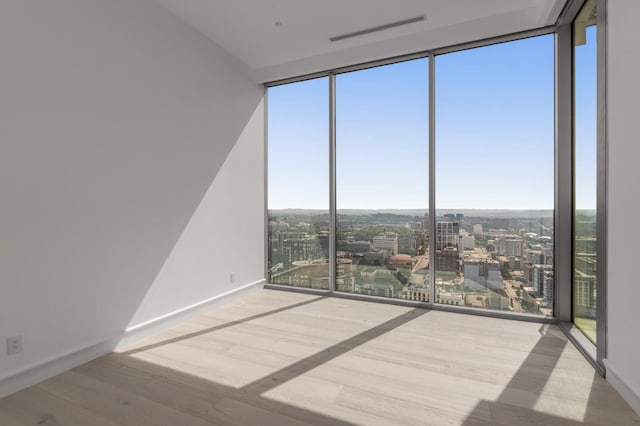 1616 W End Ave Unit 3304, Nashville, TN 37203 - unfurnished room featuring expansive windows, a view of city, and wood finished floors