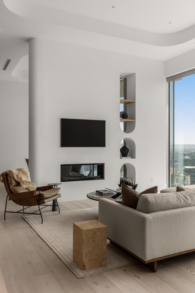 1616 W End Ave Unit 3304, Nashville, TN 37203 - living room featuring wood-type flooring, plenty of natural light, and a glass covered fireplace