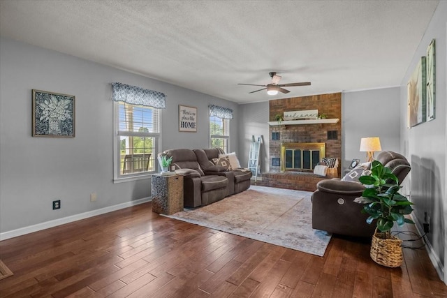 5455 Bales Rd, Cunningham, TN 37052 - living room with a ceiling fan, hardwood / wood-style flooring, a fireplace, and a textured ceiling