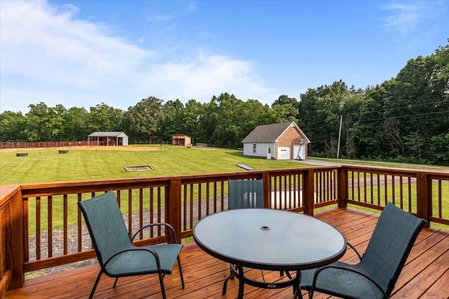 5455 Bales Rd, Cunningham, TN 37052 - wooden deck with an outbuilding, a lawn, outdoor dining space, and a detached garage