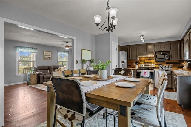 5455 Bales Rd, Cunningham, TN 37052 - dining space featuring dark wood-style flooring, a chandelier, and ceiling fan