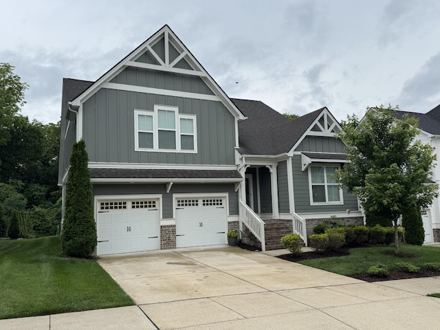 2717 Cloister Ln, Thompsons Station, TN 37179 - craftsman house with board and batten siding, an attached garage, driveway, and a front lawn