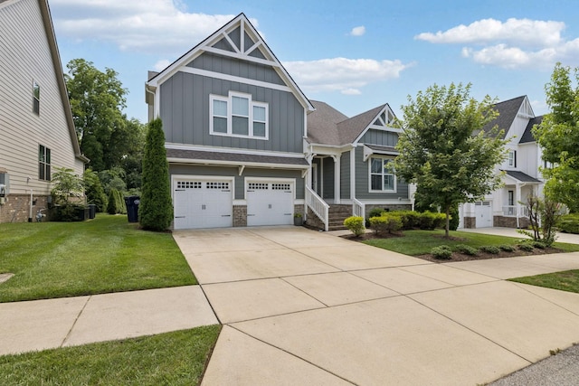 2717 Cloister Ln, Thompsons Station, TN 37179 - craftsman house featuring board and batten siding, stone siding, an attached garage, a front yard, and concrete driveway