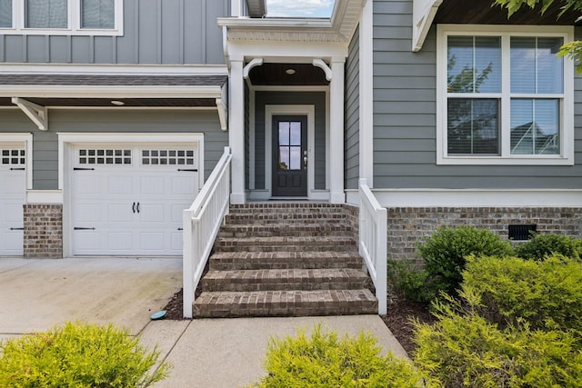 2717 Cloister Ln, Thompsons Station, TN 37179 - view of exterior entry featuring an attached garage, board and batten siding, and driveway