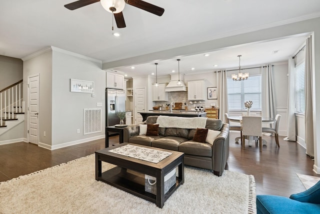 2717 Cloister Ln, Thompsons Station, TN 37179 - living room with ceiling fan, dark wood-type flooring, stairs, a chandelier, and crown molding