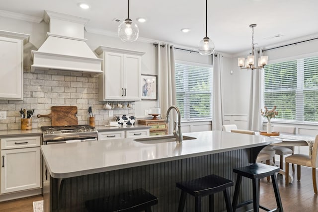 2717 Cloister Ln, Thompsons Station, TN 37179 - kitchen featuring custom exhaust hood, plenty of natural light, tasteful backsplash, white cabinetry, and ornamental molding