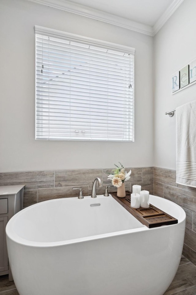 2717 Cloister Ln, Thompsons Station, TN 37179 - bathroom with tile walls, a freestanding tub, and crown molding