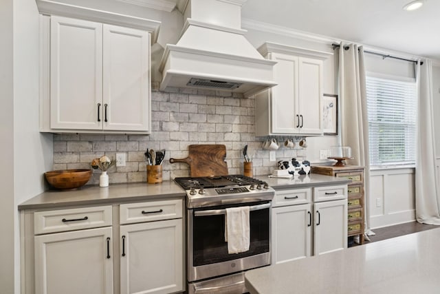 2717 Cloister Ln, Thompsons Station, TN 37179 - kitchen featuring custom range hood, stainless steel gas range, crown molding, white cabinets, and backsplash