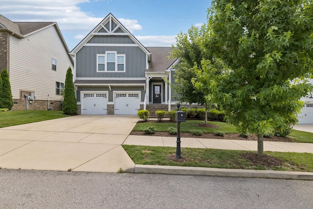 2717 Cloister Ln, Thompsons Station, TN 37179 - craftsman house with board and batten siding, driveway, an attached garage, stone siding, and a front lawn