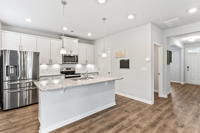 1045 Alta Vista Ln, Smyrna, TN 37167 - kitchen featuring stainless steel appliances, an island with sink, backsplash, white cabinetry, and dark wood-style flooring