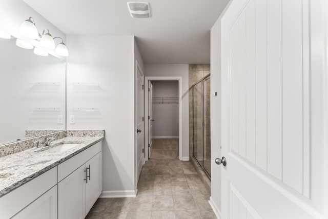 1045 Alta Vista Ln, Smyrna, TN 37167 - full bathroom featuring vanity, a stall shower, a spacious closet, and tile patterned floors