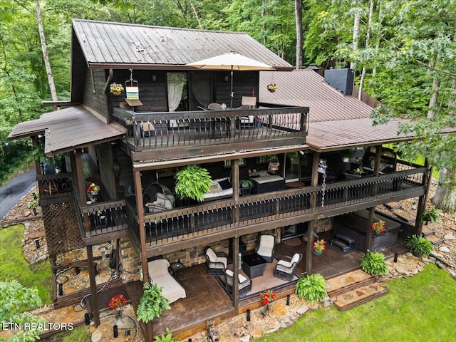 573 Hilltop Dr, Jacksboro, TN 37757 - rear view of house featuring a metal roof, a deck, a patio area, and a wooded view