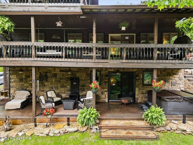 573 Hilltop Dr, Jacksboro, TN 37757 - back of house with a balcony, stone siding, and a patio area