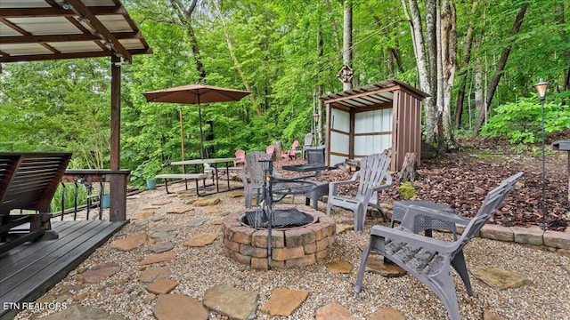 573 Hilltop Dr, Jacksboro, TN 37757 - view of patio with a fire pit, a storage shed, and a wooden deck