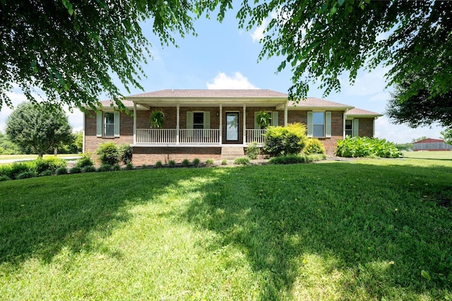 2746 Kinneys Rd, Cedar Hill, TN 37032 - ranch-style house with covered porch, a front yard, and brick siding
