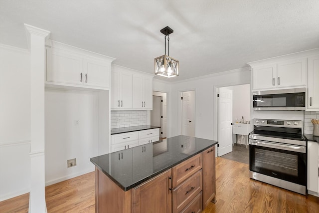 2746 Kinneys Rd, Cedar Hill, TN 37032 - kitchen featuring stainless steel appliances, tasteful backsplash, white cabinets, light wood finished floors, and ornamental molding