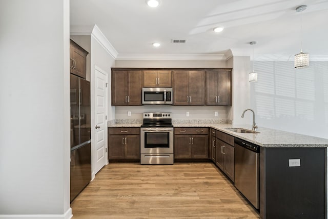 2557 Napa Valley Way, Columbia, TN 38401 - kitchen featuring appliances with stainless steel finishes, a peninsula, dark brown cabinets, crown molding, and light wood-style floors