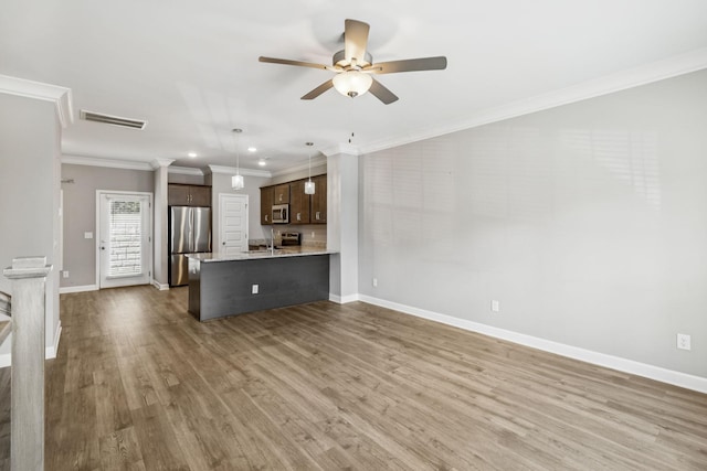 2557 Napa Valley Way, Columbia, TN 38401 - unfurnished living room with ceiling fan, wood finished floors, ornamental molding, and recessed lighting