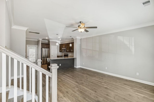 2557 Napa Valley Way, Columbia, TN 38401 - unfurnished living room featuring ornamental molding, wood finished floors, ceiling fan, recessed lighting, and stairs