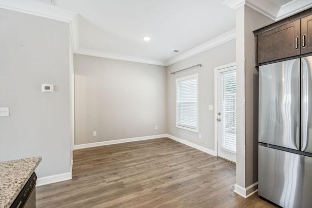 2557 Napa Valley Way, Columbia, TN 38401 - kitchen featuring freestanding refrigerator, ornamental molding, light wood-type flooring, dark brown cabinets, and light stone counters