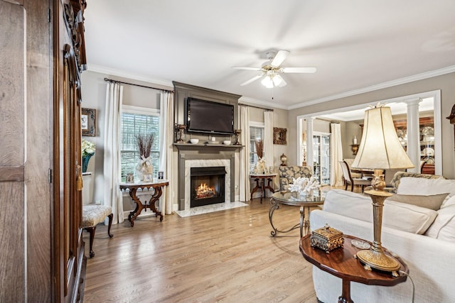 314 W 6th St, Columbia, TN 38401 - living room featuring ceiling fan, a premium fireplace, crown molding, and light wood-style flooring