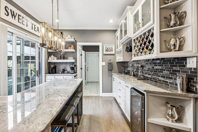 314 W 6th St, Columbia, TN 38401 - kitchen featuring open shelves, beverage cooler, ornamental molding, tasteful backsplash, and light stone counters
