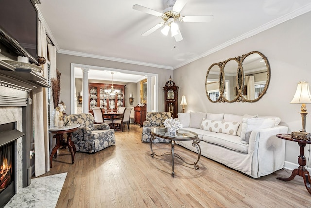 314 W 6th St, Columbia, TN 38401 - living area with a fireplace, light wood finished floors, ceiling fan, ornamental molding, and a chandelier