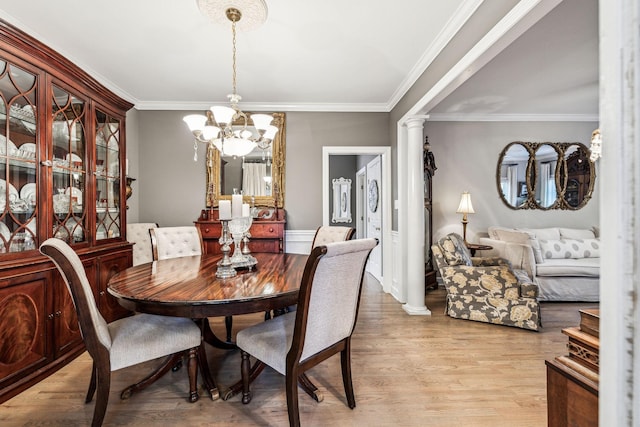 314 W 6th St, Columbia, TN 38401 - dining room with light wood-style floors, ornamental molding, a chandelier, and decorative columns